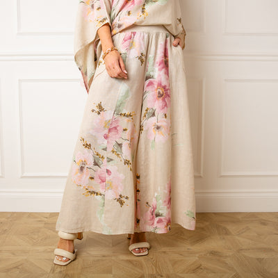 The stone cream Bouquet Print Linen Trousers with a wide stretchy elasticated waistband for extra comfort 