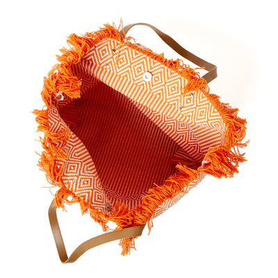 The orange Woven Beach Bag made from woven cotton with a contrasting brown faux leather strap 